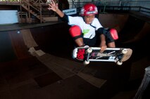 Ian Tamanaha, 10, of Mililani, Hawaii, performs a trick while skating one of the bowls at the Hickam Skate Hangar Aug. 22 at Joint Base Pearl Harbor-Hickam, Hawaii. The converted hangar is the only indoor wooden facility on all the Hawaiian Islands. It also boasts the only wooden keyhole bowls, or empty swimming pool shaped ramps, on Oahu. In addition, it has a 15,000 square foot street course, multiple mini ramps, 12-foot vertical ramp with a 14-foot tombstone connected to a saddle and three-quarter pipe. (U.S. Air Force photo/Staff Sgt. Mike Meares)