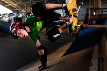 Seth Lefferts, 13, son of Tech Sgt. Chad Lefferts, Pacific Air Forces Headquarters, performs a trick on his skateboard at the Hickam Skate Hangar Aug. 21 at Joint Base Pearl Harbor-Hickam, Hawaii. The converted hangar is the only indoor wooden facility on all the Hawaiian Islands. It also boasts the only wooden keyhole bowls, or empty swimming pool shaped ramps, on Oahu. In addition, it has a 15,000 square foot street course, multiple mini ramps, 12-foot vertical ramp with a 14-foot tombstone connected to a saddle and three-quarter pipe. (U.S. Air Force photo/Staff Sgt. Mike Meares)