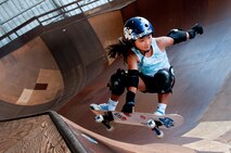 Kody Tamanaha, 8, of Mililani, Hawaii, performs a trick while skating one of the bowls at the Hickam Skate Hangar Aug. 16 at Joint Base Pearl Harbor-Hickam, Hawaii. The converted hangar is the only indoor wooden facility on all the Hawaiian Islands. It also boasts the only wooden keyhole bowls, or empty swimming pool shaped ramps, on Oahu. In addition, it has a 15,000 square foot street course, multiple mini ramps, 12-foot vertical ramp with a 14-foot tombstone connected to a saddle and three-quarter pipe. (U.S. Air Force photo/Staff Sgt. Mike Meares)