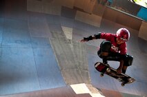 Ian Tamanaha, 10, of Mililani, Hawaii, performs a trick while skating one of the bowls at the Hickam Skate Hangar Aug. 16 at Joint Base Pearl Harbor-Hickam, Hawaii. The converted hangar is the only indoor wooden facility on all the Hawaiian Islands. It also boasts the only wooden keyhole bowls, or empty swimming pool shaped ramps, on Oahu. In addition, it has a 15,000 square foot street course, multiple mini ramps, 12-foot vertical ramp with a 14-foot tombstone connected to a saddle and three-quarter pipe. (U.S. Air Force photo/Staff Sgt. Mike Meares)