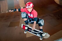 Ian Tamanaha, 10, of Mililani, Hawaii, performs a trick while skating one of the bowls at the Hickam Skate Hangar Aug. 16 at Joint Base Pearl Harbor-Hickam, Hawaii. The converted hangar is the only indoor wooden facility on all the Hawaiian Islands. It also boasts the only wooden keyhole bowls, or empty swimming pool shaped ramps, on Oahu. In addition, it has a 15,000 square foot street course, multiple mini ramps, 12-foot vertical ramp with a 14-foot tombstone connected to a saddle and three-quarter pipe. (U.S. Air Force photo/Staff Sgt. Mike Meares)