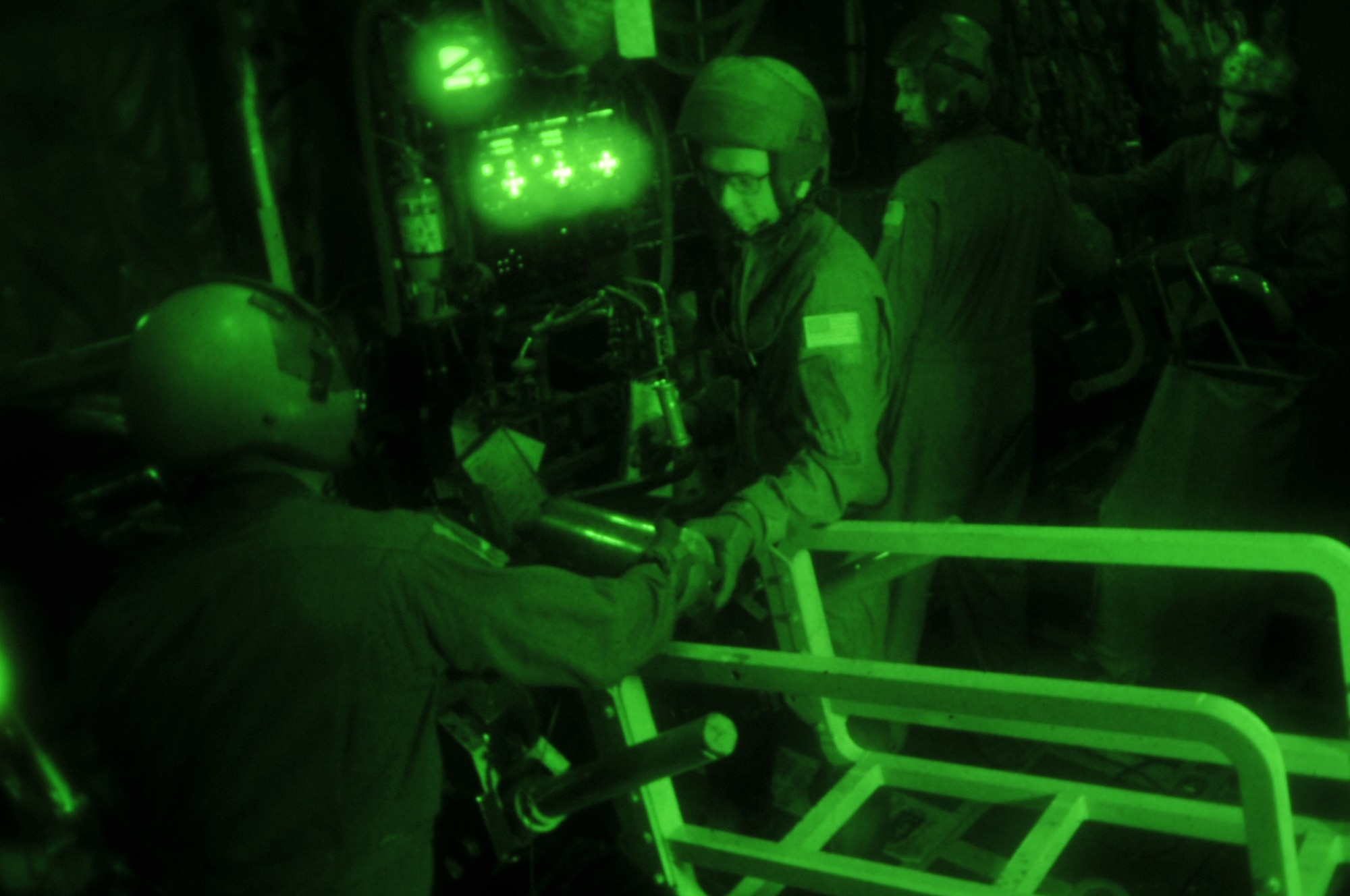 Aerial gunners Staff Sgt. Ben and Airman 1st Class Sean, reload a M102 cannon round aboard an AC-130U Spooky gunship during exercise Teak Knife 12-3 above Pilsung Range, Republic of Korea, Sept. 12, 2012. The exercise is designed to enhance the combat readiness of U.S. and Republic of Korea Special Operations and supporting forces through combined and joint live-fire training. (U.S. Air Force photo/Staff Sgt. Craig Cisek)