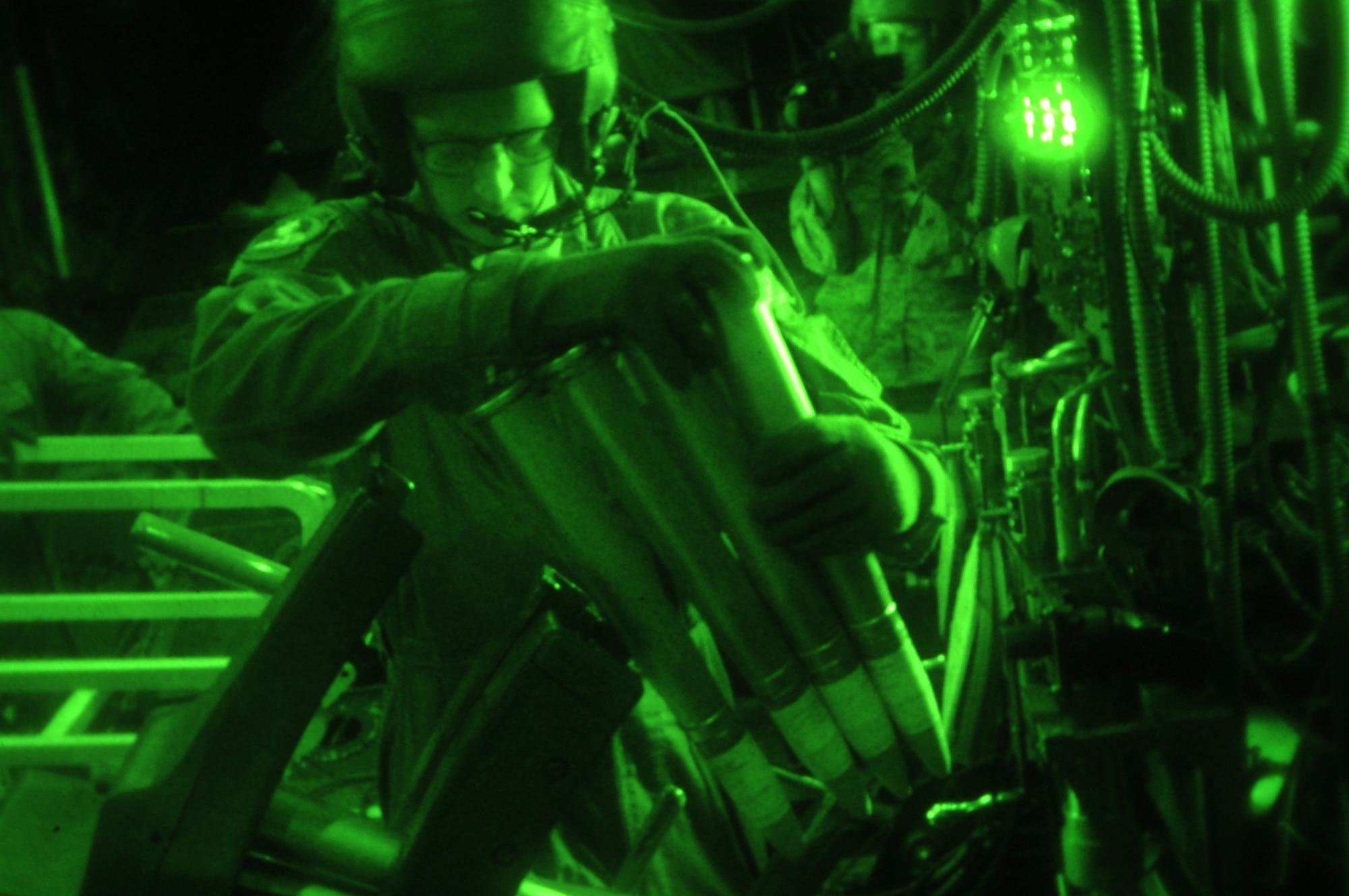 Aerial gunner Airman 1st Class Sean reloads 40mm rounds into an auto-cannon aboard an AC-130U Spooky gunship during exercise Teak Knife 12-3 above Pilsung Range, Republic of Korea, Sept. 12, 2012. The exercise is part of a continuous exercise program between U.S. and ROK forces to help strengthen and enhance the readiness of Republic of Korea and U.S. forces.  (U.S. Air Force photo/Staff Sgt. Craig Cisek)