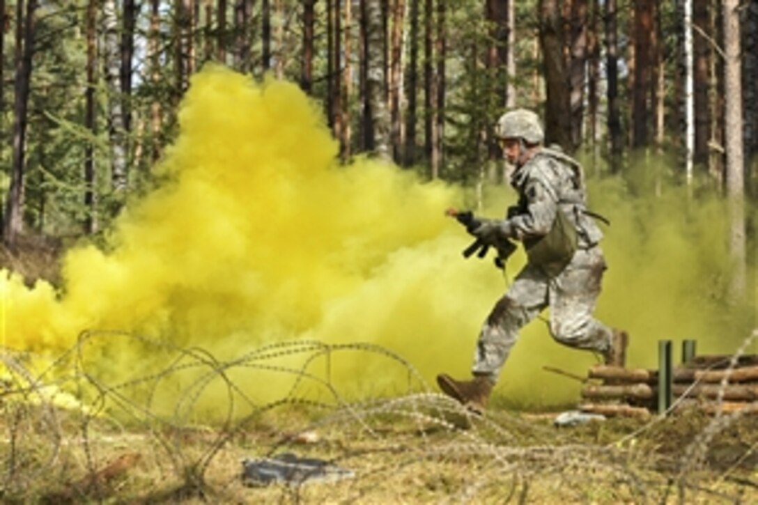 U.S. Army Capt. Christopher Harris moves through an obstacle during an U.S. Army Europe Expert Field Medical Badge examination in Grafenwoehr, Germany, Sept. 20, 2012. The exam provides multinational and U.S. service members with common standards and objectives for treating the sick and wounded, and improves communication among the frontline medical professionals fighting together. 