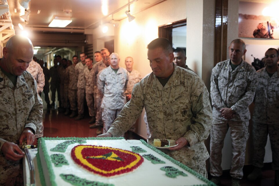 Brig. Gen. Frederick M. Padilla prepares a piece of birthday cake for both the longest-serving and newest division Marines during the 70th birthday ceremony for 3rd Marine Division at the division’s headquarters building Sept. 17. Padilla is the commanding general of the division, which is part of III Marine Expeditionary Force. 
