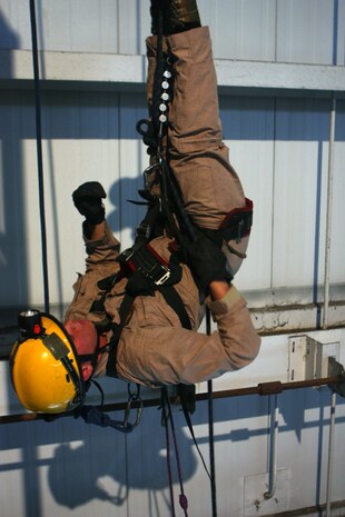 Randall’s Island, NEW YORK – Lance Cpl. Connad Higgins hangs upside down, three stories high during high-angle-rope- rescue training at the New York City Fire Department’s Training Academy. While at the training academy CBIRF Marines will get a variety of technical rescue training including vehicle extrication and collapse structure training. (Official Marine Corps Photo by Sgt. Frances L. Goch, Released)