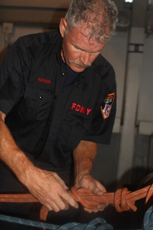 RandallÕs Island, NEW YORK Ð Firefighter and instructor with the New York City Fire Department, Dave Raynor, sets up the rope systems for the Marines to do high angle rescue training later in the morning. Raynor has been with FDNY for more than 28 years and continuously conducts advanced rope training across the country.