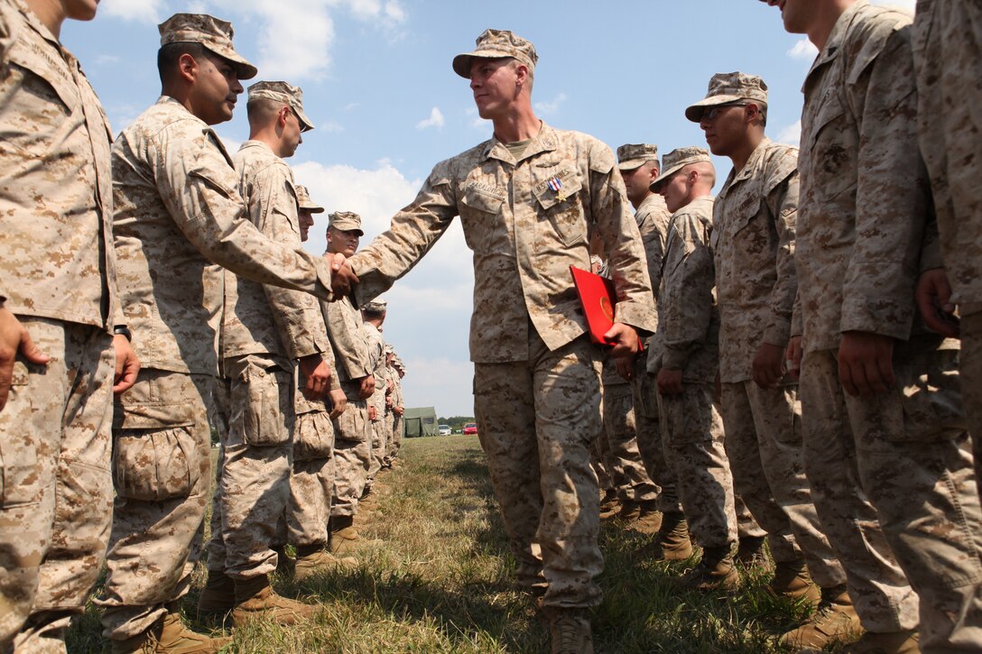 Marines assigned to the 4th Reconnaissance Battalion congratulate Staff Sgt. Alec Haralovich, after he was presented the Silver Star Medal, the nation’s third highest award for combat valor. After Haralovich was shot twice in his body armor by an insurgent, he destroyed an enemy stronghold with a rocket and led his Marines on a two-hour assault after their ambushers during an Afghanistan deployment in 2011. Haralovich is a reconnaissance Marine assigned to E Company, 4th Reconnaissance Bn., 4th Marine Division.