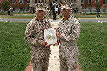 Colonel Andy Bianca (right), Marine Corps Systems Command’s Program Manager for Infantry Weapon Systems, presents Corporal Andres Medina with his promotion warrant in early September