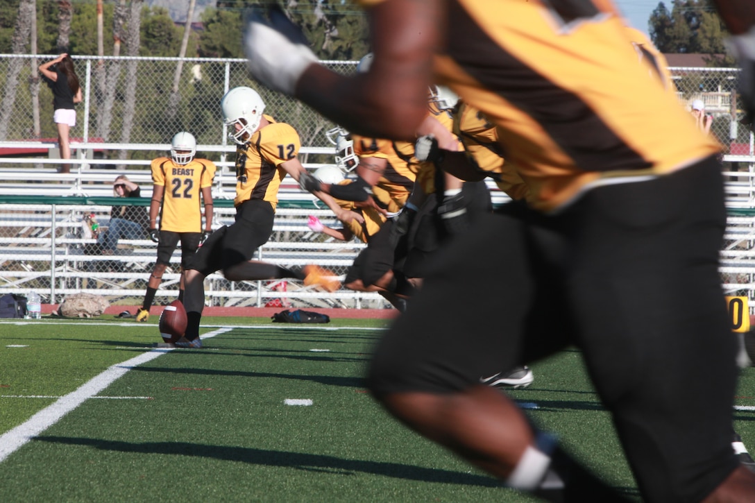 First Marine Logistics Group Beast fullback Eddie Morefield, 13, runs for a touchdown against the 1st Radio Battalion Freqs, at the 11-Area football field at Marine Corps Base Camp Pendleton, Calif. The Beast beat the Freqs 56-0 and improved to 6-0 for the season.