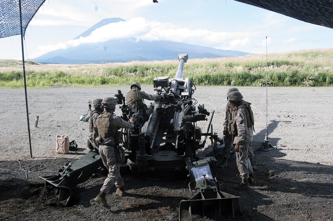 Marines from Battery O, 5th Battalion, 14th Marine Regiment, 4th Marine Division prepare to fire artillery rounds from an M777A2 155 mm howitzer at East Fuji Maneuver Area, Japan Sept. 11. Battery O is in Japan as a part of the Unit Deployment Program, a program designed to increase the training level and unit continuity of Marine Corps units stationed in the continental United States. Realistic scenarios and combined exercises are a highlight of the UDP, bringing Marines of many different units together, sometimes with foreign forces. (U.S. Marine Corps photo by Pfc. Terence G. Brady/Released)