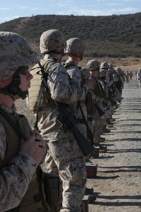 Marines stand facing the range tower to wait for the command to turn around and begin firing during the table two portion of annual M16-A4 service rifle qualifications on Carlos Hathcock Range Complex aboard Marine Corps Air Station Miramar, Calif., Sept 20. During table two, Marines engage moving targets and targets from 25 yards away.