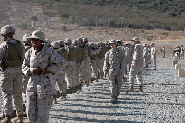 Range coaches stand behind their shooters while they conduct table two of annual M16-A4 service rifle qualification on Carlos Hathcock Range Complex aboard Marine Corps Air Station Miramar, Calif., Sept 20. During table two, Marines engage targets from 25 yards away.