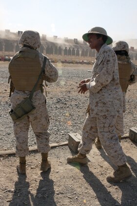 Cpl. India Harris, a range coach with Headquarters and Headquarters Squadron and a Crescent City, Fla., native, helps a Marine during the table two portion of annual M16-A4 service rifle qualification on Carlos Hathcock Range Complex aboard Marine Corps Air Station Miramar, Calif., Sept 20. During table two, Marines shoot at targets that simulate a human body and display their skills in head and pelvis shots.