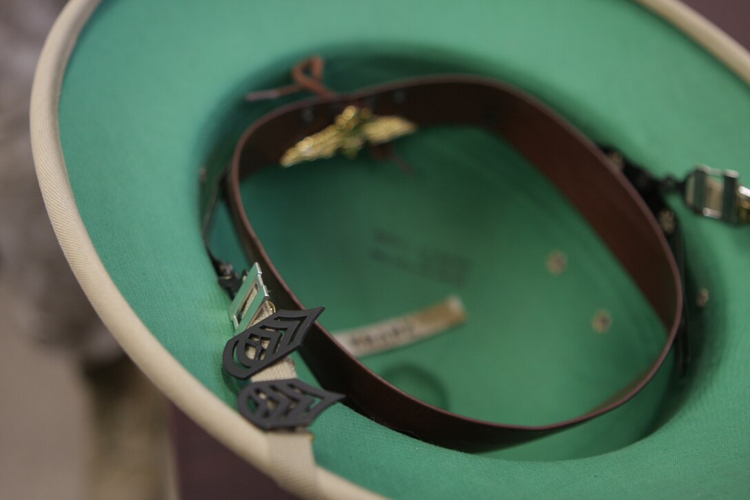 Different ranks are pinned on to a range coach?s cover as a thank you for helping them qualify as an expert on Carlos Hathcock Range Complex aboard Marine Corps Air Station Miramar, Calif., Sept 20. It is a tradition for Marines to give coaches their rank insignia if it is their first time shooting expert on the range.