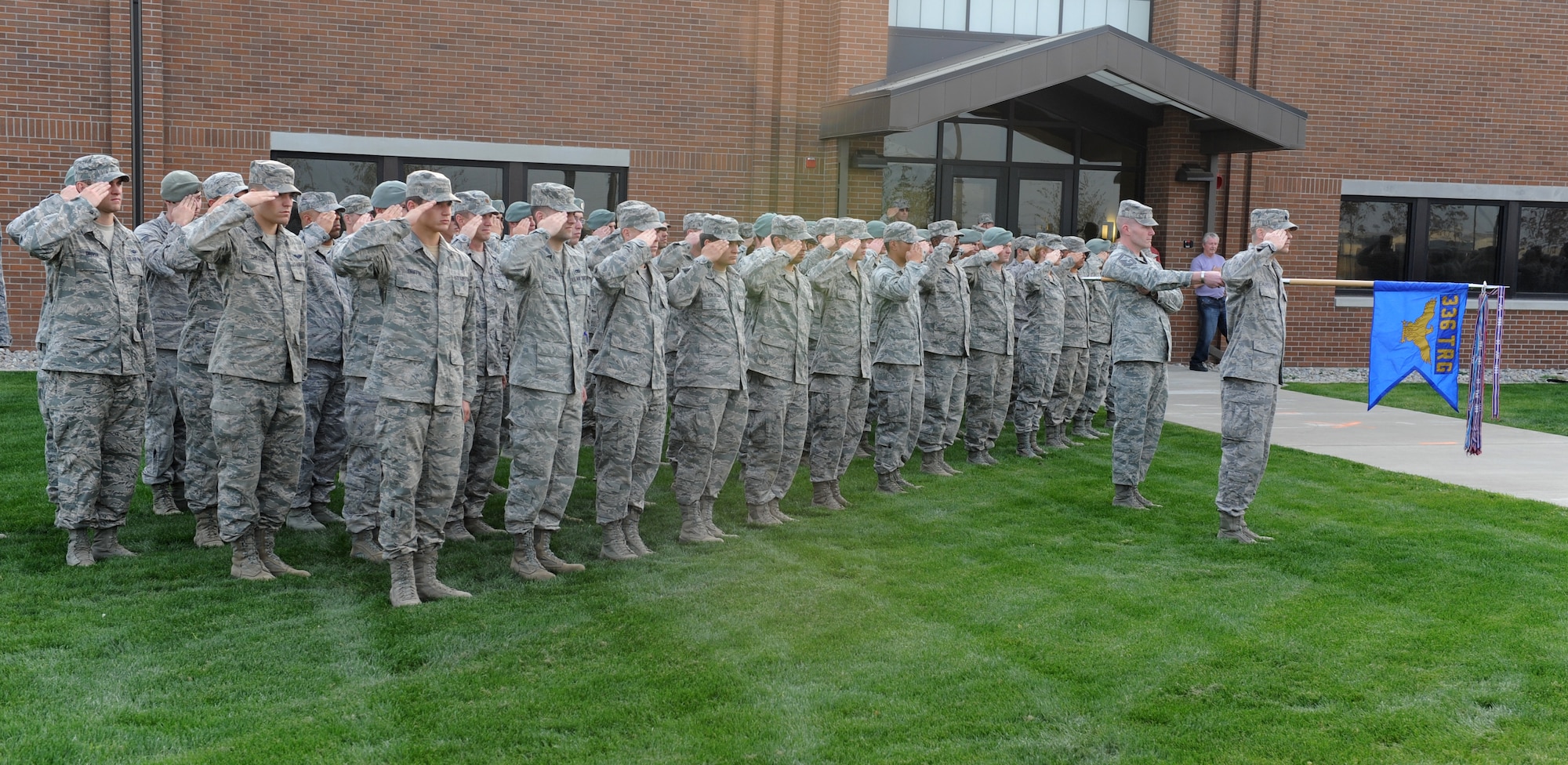 Members of Team Fairchild salute during a Retreat Ceremony honoring prisoners of war and those missing in action at Fairchild Air Force Base, Wash. Sept. 21, 2012. The ceremony was held at the 336th Training Group headquarters building flagpole. (U.S. Air Force photo by Staff Sgt. Michael Means)