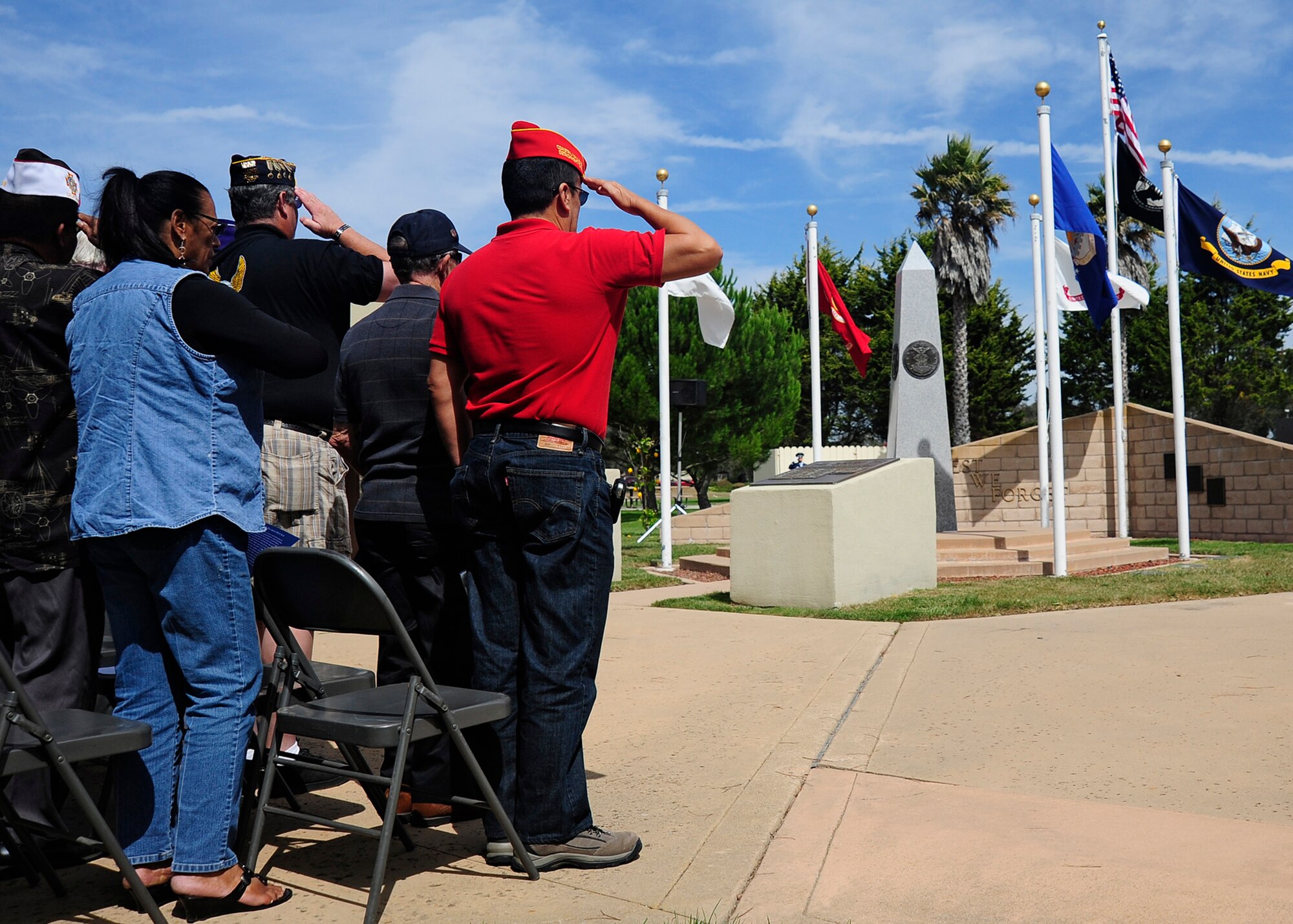 VANDENBERG AIR FORCE BASE, Calif. -- Team V members salute the flag during the singing of the National Anthem at the POW/MIA Recognition Day Ceremony held here Friday, Sept. 21, 2012. This annual ceremony held at Vandenberg's POW/MIA monument is dedicated to honoring our American prisoners of war and missing in action. (U.S. Air Force photo/Michael Peterson)