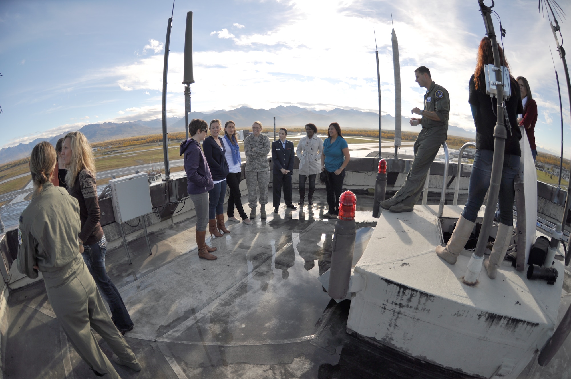 Capt. Graham Stewart, 525th Fighter Squadron, briefed F-22 spouses on the landing sequence of the F-22. The spouses of active duty and Reserve F-22 pilots from the 525th and 302nd Fighter Squadrons received an up close look at the F-22 mission during the Spouses Blue Carpet day here Sept. 21. The tour consisted of a commanders briefing, and tours of the Air Traffic Control Tower, Egress Trainer and Hush House. (U.S. Air Force Reserve/Tech. Sgt. Dana Rosso) 