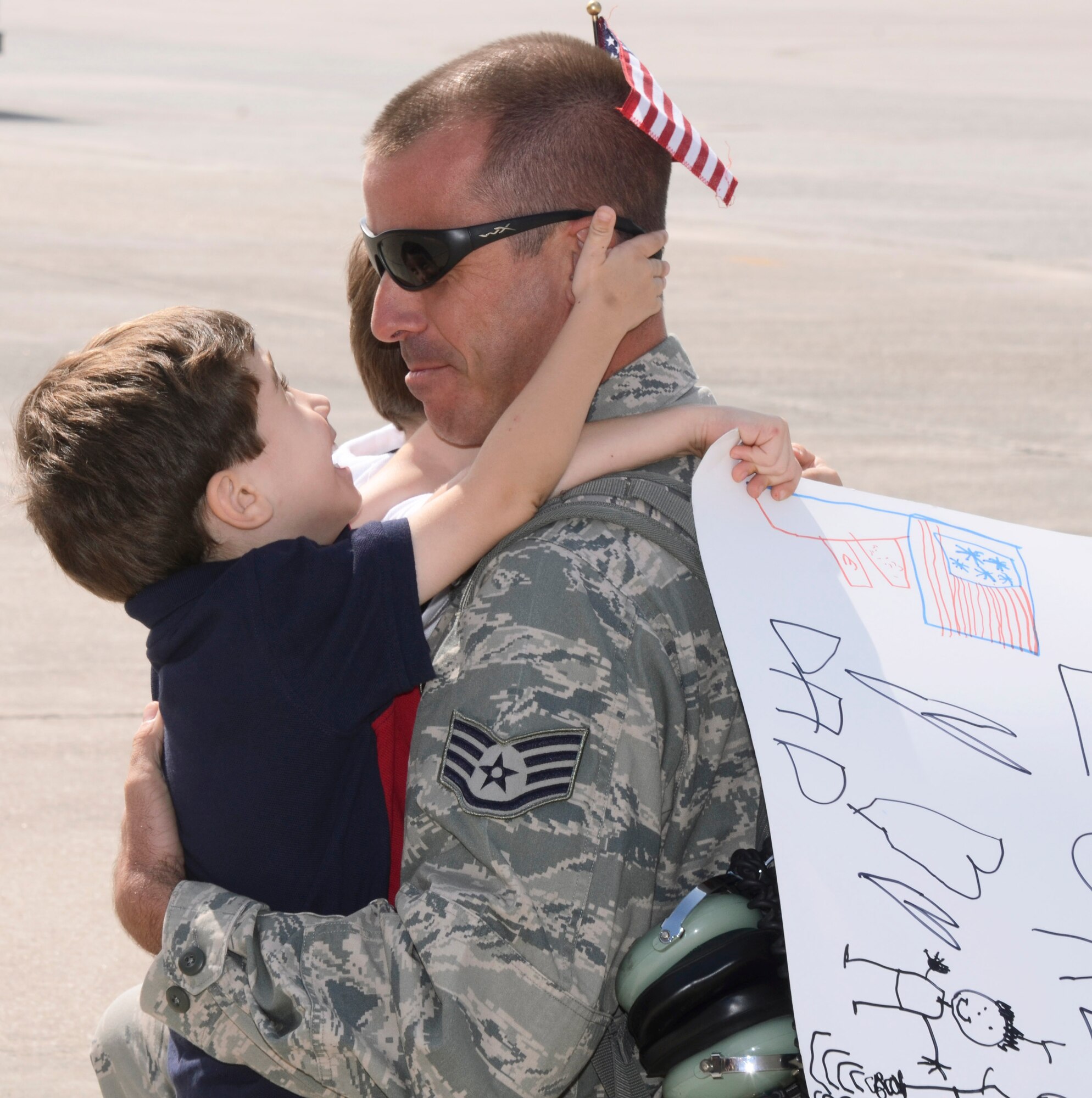 Members of the 94th Airlift Wing is welcomed home by his son during a homecoming ceremony at Dobbins Air Reserve Base on Sept. 21. Over 100 Reservists are scheduled to return to Dobbins ARB from the Middle East beginning today and concluding Monday. (U.S. Air Force photo/Don Peek)