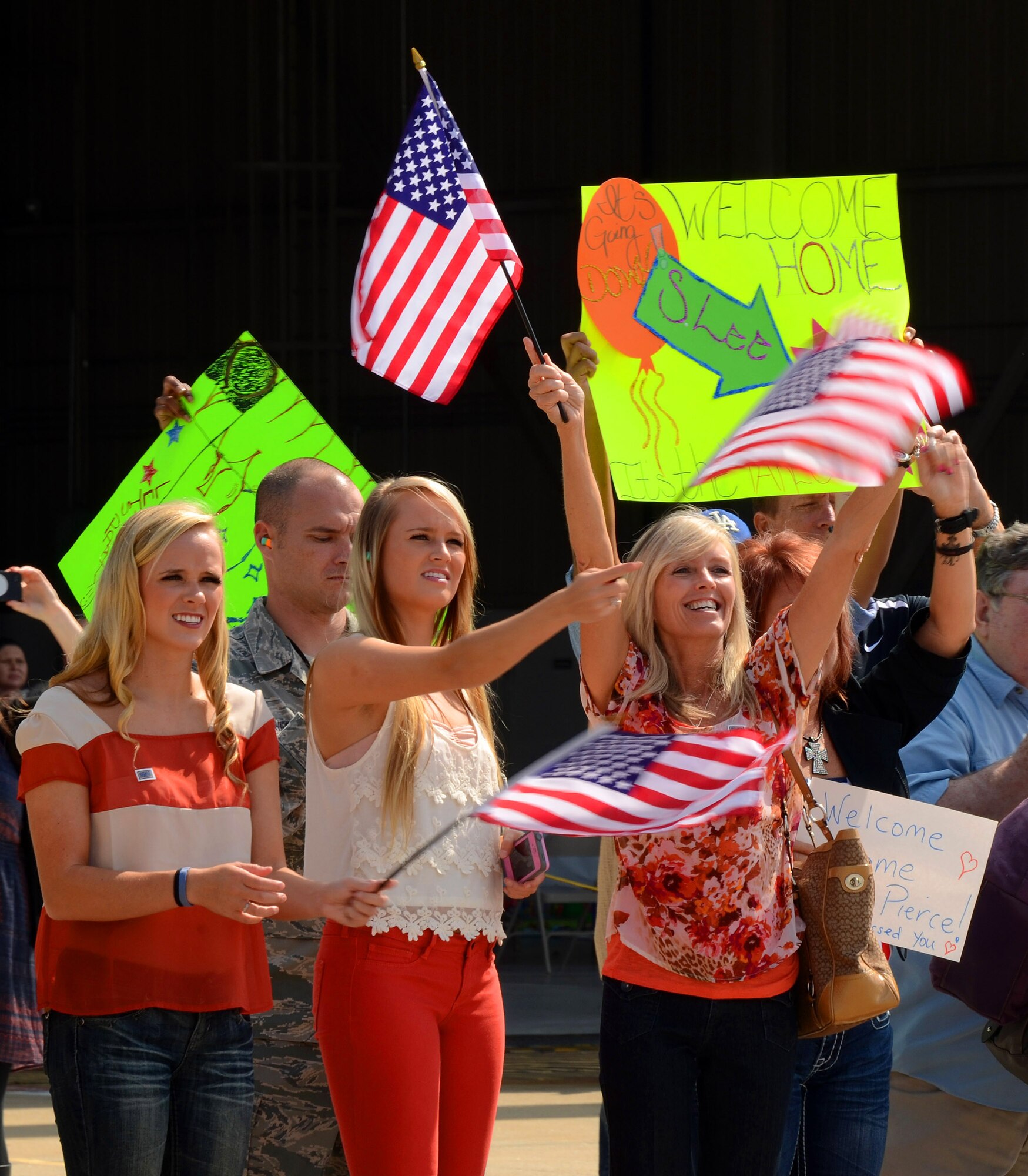 Family members are anxiously awaiting Airmen from the 94th Airlift Wing to disembark an incoming C-130H at Dobbins Air Reserve Base on Sept. 21. Over 100 Reservists are scheduled to return to Dobbins ARB from the Middle East beginning today and concluding Monday. (U.S. Air Force photo/Brad Fallin)