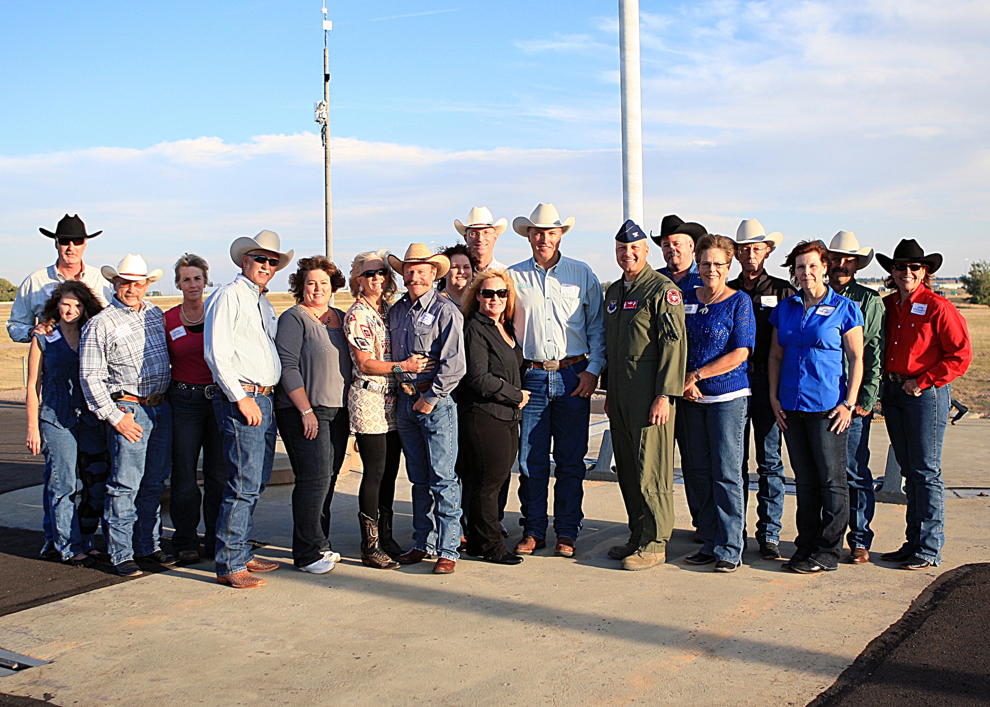 Col. Christopher Coffelt, 90th Missile Wing commander, and Col. Scott Fox, 20th Air Force vice commander, pose with Cheyenne Frontier Days committee members during their “Behind the Gates” Tour on F. E. Warren Air Force Base, Wyo., Sept. 15, at Uniform 1. (U.S. Air Force photo by Matt Bilden)