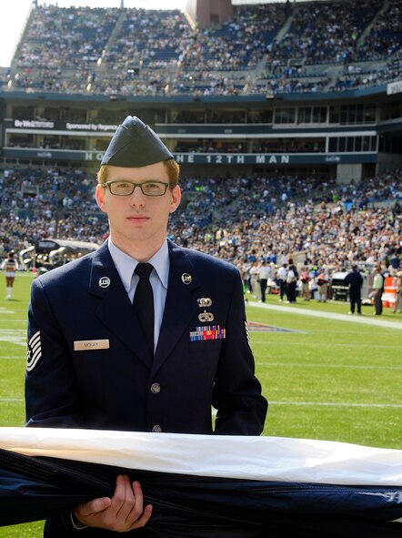 Tech Sgt. David McKay, 446th Airlift Wing, was one of more than 30 U.S. Air Force Airmen from the 62nd and 446th Airlift Wings presenting the U.S. flag on the field during pregame ceremonies for the Sept. 16, Seattle Seahawks home opener against the Dallas Cowboys at Century Link field in Seattle. This was the first of three opportunities for the two units to work together in support of the Seattle Seahawks for the 2012 National Football League season. (U.S. Air Force photo by Master Sgt. Todd Wivell)