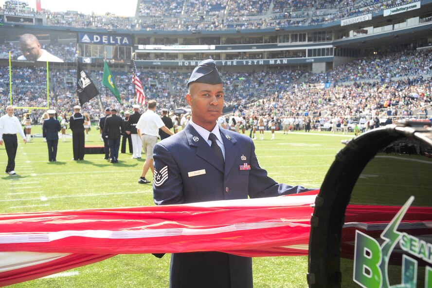 Tech Sgt. King Ellis, 446th Maintenance Operations Flight, was one of more than 30 U.S. Air Force Airmen from the 62nd and 446th Airlift Wings presenting the U.S. flag on the field during pregame ceremonies for the Sept. 16, Seattle Seahawks home opener against the Dallas Cowboys at Century Link field in Seattle. This was the first of three opportunities for the two units to work together in support of the Seattle Seahawks for the 2012 National Football League season. (U.S. Air Force photo by Master Sgt. Todd Wivell)