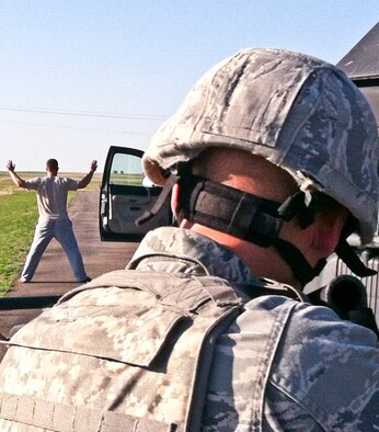 Airman Brett Oster, 90th Missile Security Forces Squadron, challenges a vehicle during a training exercise in the F. E. Warren Air Force Base, Wyo., missile complex. Staff Sgt.  Matthew Varga, 319th Missile Squadron facility manager, played the driver during the exercise. (Stock photograph)