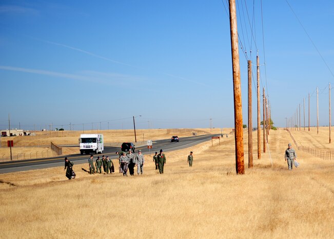 Airmen from the 9th Operations Group patrol for trash on Doolittle Dr. Beale Air Force Base, Calif., Sept. 21, 2012. Each group within the 9th Reconnaissance Wing adopted a road on base to clean as part of Beale Pride Day. (U.S. Air Force photo by Senior Airman Shawn Nickel/Released)