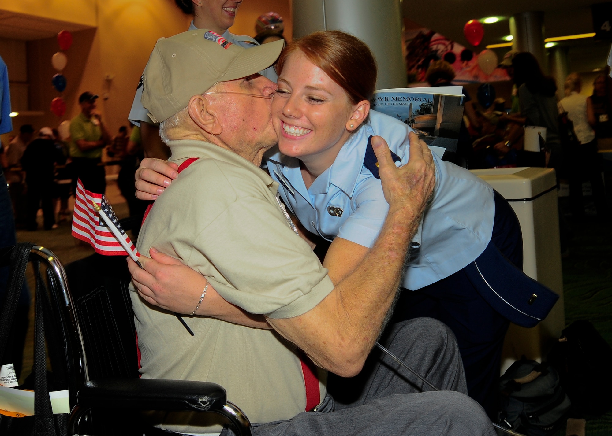 2nd Lieutenant Elizabeth Scarberry, 6th Logistics Readiness Squadron plans and integration officer in charge embraces a World War II veteran upon arrival with the seventh Honor Flight West Central Florida at the St. Petersburg Clearwater International Airport, Fla., Sept. 18, 2012.  Seventy-seven WWII veterans were flown to Washington D.C. to tour the WWII memorial. (U.S. Air Force photo by Staff Sgt. Angela Ruiz)