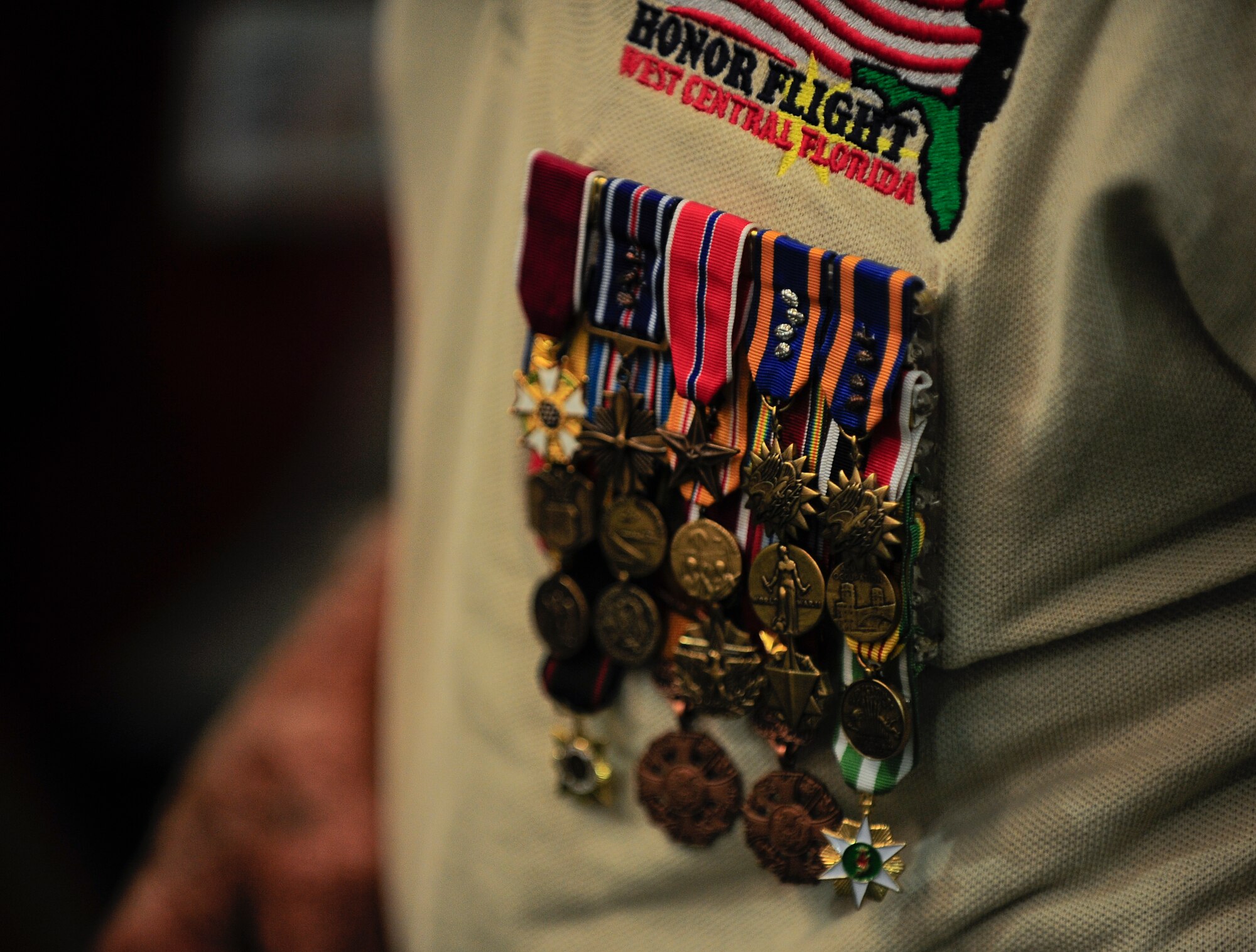 Military decorations are displayed on World War II veteran John Crosby’s shirt as he returns home following the seventh Honor Flight of West Central Florida Sept. 18, 2012. The Honor Flight Network is a non-profit organization that transports our heroes to Washington, D.C. to visit and reflect at their memorials. (U.S. Air Force photo by Staff Sgt. Angela Ruiz)
