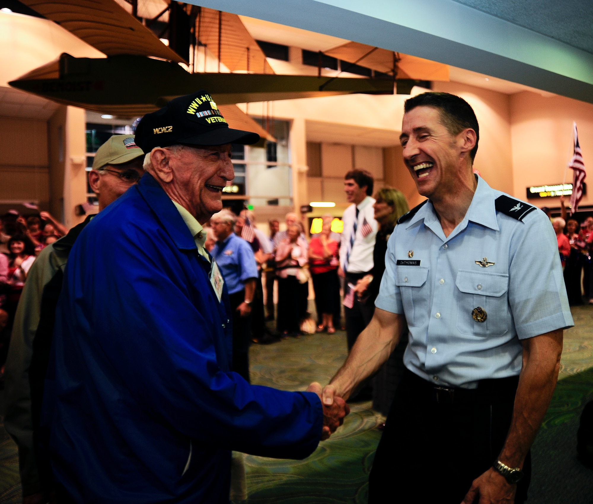 World War II veteran Bill Short is welcomed home by Col. Scott DeThomas, 6th Air Mobility Wing commander, at the St. Petersburg Clearwater International Airport, Fla., Sept. 18, 2012.  DeThomas and members of Team MacDill welcomed 77 WWII veterans home upon completion of the seventh Honor Flight of West Central Florida. (U.S. Air Force photo by Staff Sgt. Angela Ruiz)
