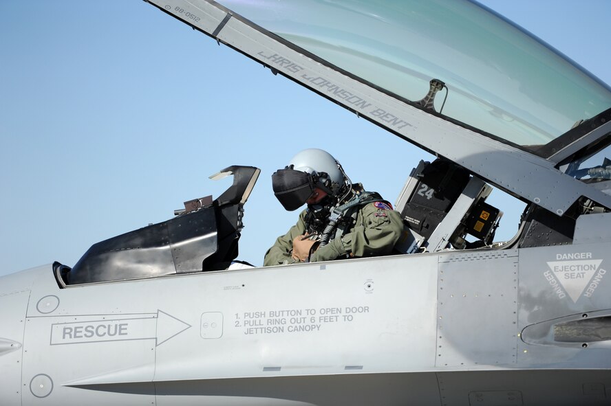 Capt. Dell Schledewitz, South Dakota Air National Guard’s 175th Fighter Squadron F-16 pilot, adjusts his safety harness prior to a mission at Ellsworth Air Force Base, S.D., Sept. 18, 2012. The F-16 is a compact, multi-role fighter aircraft that is highly maneuverable and has proven itself in air-to-air combat and air-to-surface operations. (U.S. Air Force photo by Airman 1st Class Hrair H. Palyan/Released)