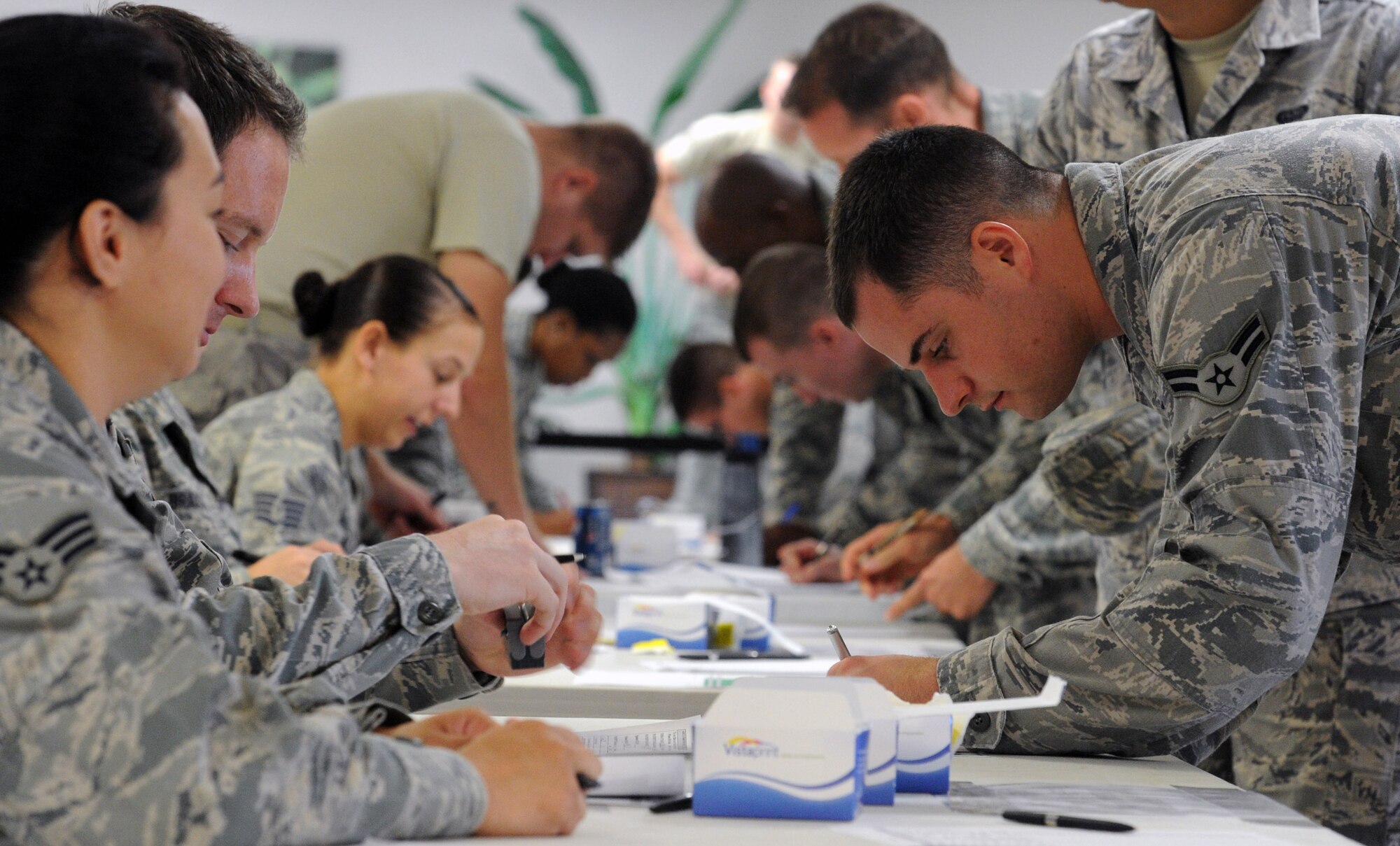 Medical personnel assist patients with screening paperwork at the Makai Recreation Center Sept. 20 at Joint Base Pearl Harbor-Hickam, Hawaii, as part of the "SHOTEX" mass-immunization exercise.  SHOTEX was a Navy-sponsored mass-immunization exercise involving medical personnel from Headquarters Pacific Air Forces, 13th Air Force, Naval Health Clinic Hawaii, the 15th Wing Medical Group and the 154th Medical Group aiming to vaccinate approximately 12,000 military personnel and Category 1 and 5 civilian personnel. (U.S. Air Force photo by Staff Sgt. Nathan Allen)