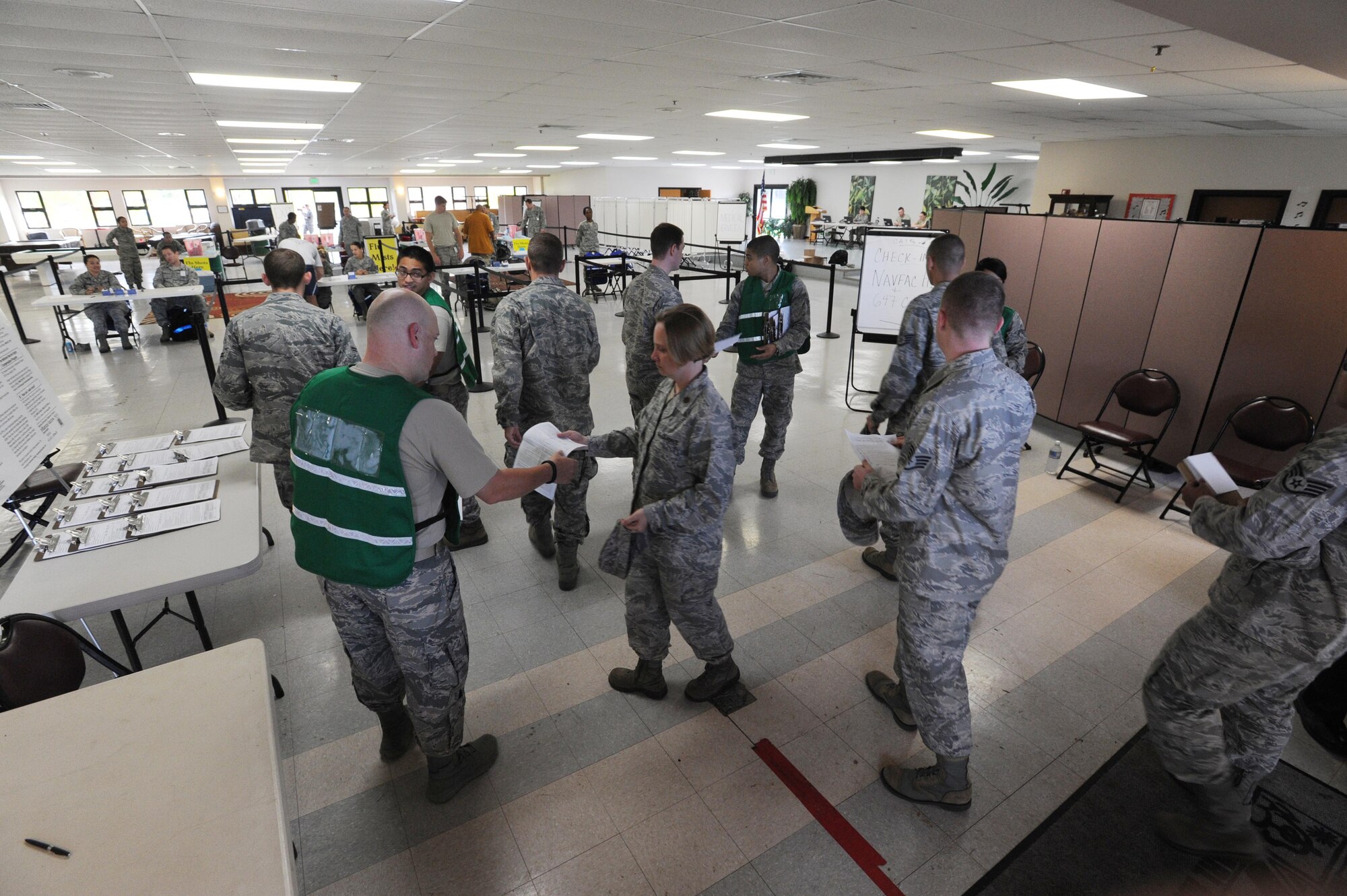 Airmen are greeted by medical personnel at the Makai Recreation Center Sept. 20 at Joint Base Pearl Harbor-Hickam, Hawaii, to recieve a flu vaccine as part of the "SHOTEX" mass-immunization exercise.  SHOTEX was a Navy-sponsored mass-immunization exercise involving medical personnel from Headquarters Pacific Air Forces, 13th Air Force, Naval Health Clinic Hawaii, the 15th Wing Medical Group and the 154th Medical Group aiming to vaccinate approximately 12,000 military personnel and Category 1 and 5 civilian personnel. (U.S. Air Force photo by Staff Sgt. Nathan Allen)