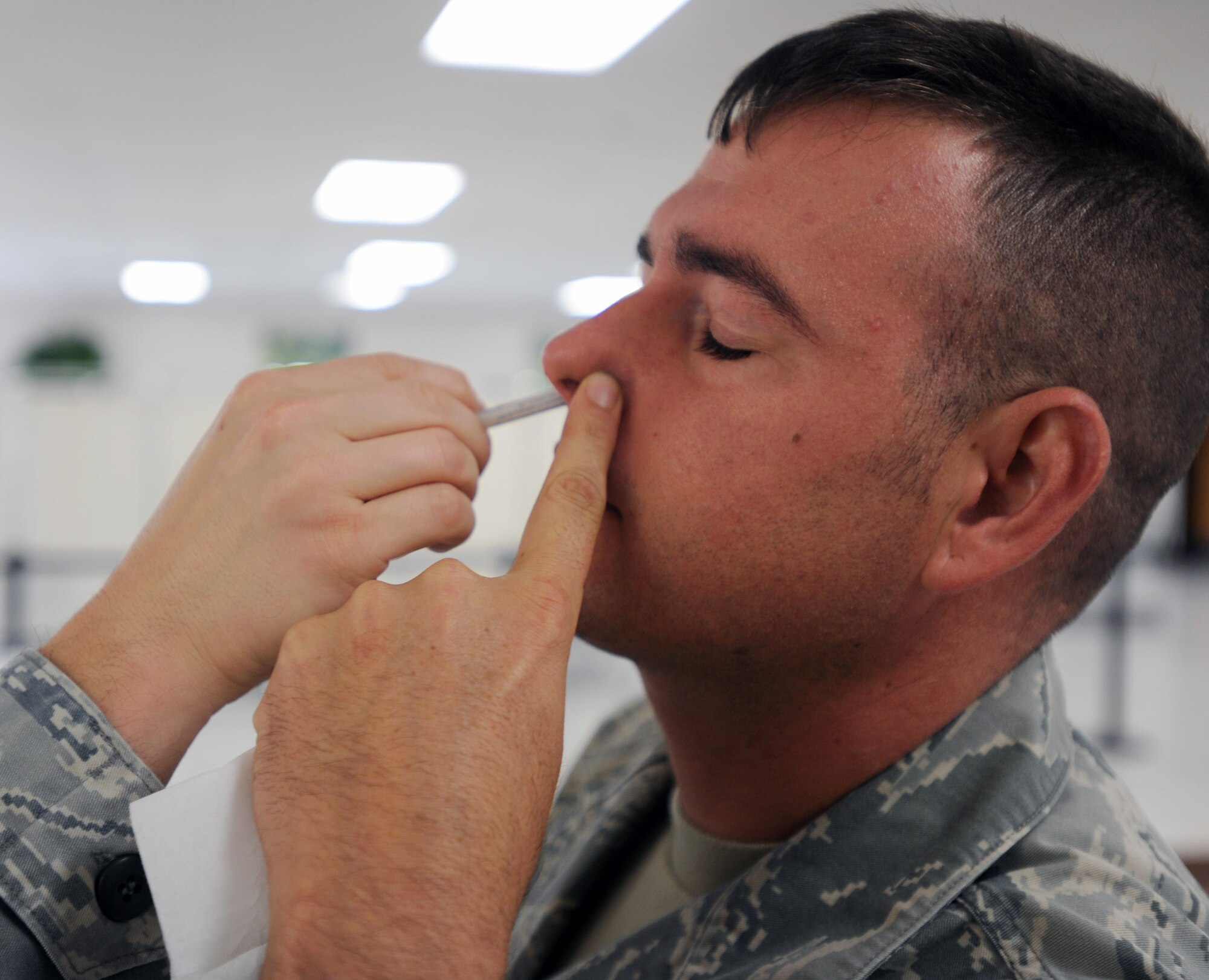 Tech. Sgt. Roy Barden, 647th Security Forces Squadron kennel master, recieves the "flu mist" vaccine Sept. 20 at Joint Base Pearl Harbor-Hickam, Hawaii, as part of the "SHOTEX" mass-immunization exercise.  SHOTEX was a Navy-sponsored mass-immunization exercise involving medical personnel from Headquarters Pacific Air Forces, 13th Air Force, Naval Health Clinic Hawaii, the 15th Wing Medical Group and the 154th Medical Group aiming to vaccinate approximately 12,000 military personnel and Category 1 and 5 civilian personnel. (U.S. Air Force photo by Staff Sgt. Nathan Allen)