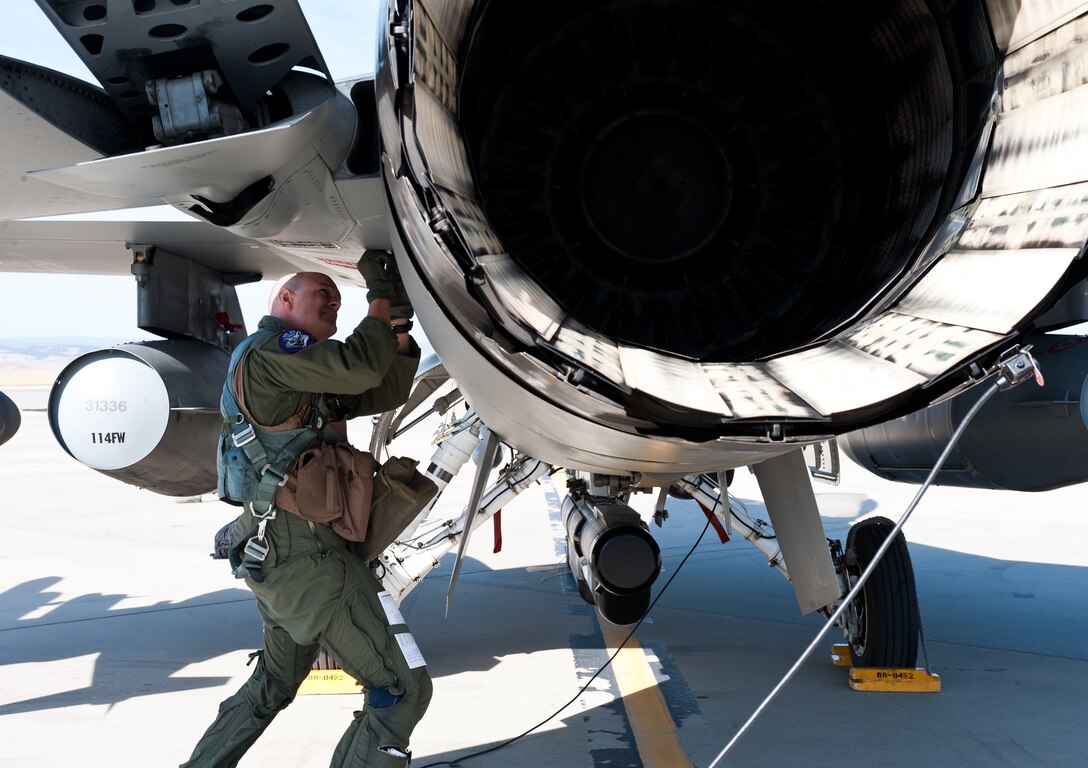 Capt. Travis Barnett, 175th Fighter Squadron F-16 pilot, performs pre-flight checks on his aircraft prior to a mission at Ellsworth Air Force Base, S.D., Sept. 19, 2012. The 175th FS Fighting Lobos operated out of Ellsworth Sept. 17 to 21 as part of the South Dakota Air National Guard’s 2012 Live Drop exercise. (U.S Air Force photo by Airman 1st Class Alystria Maurer/Released)
