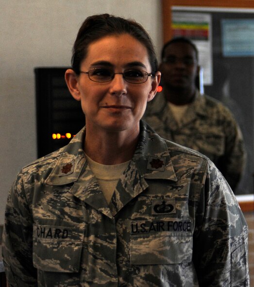 Maj. Dawn Chard, Air Force Financial Services Center commander, listens as Gary Gualano, AFFSC director, praises her hard work and leadership during an event in the center's main lobby on Ellsworth Air Force Base, S.D., Sept. 19, 2012. Chard was responsible for ensuring a smooth transition of the AFFSC from a military organization to a civilian-operated work center. (U.S. Air Force photo by Airman Ashley J. Woolridge/Released) 