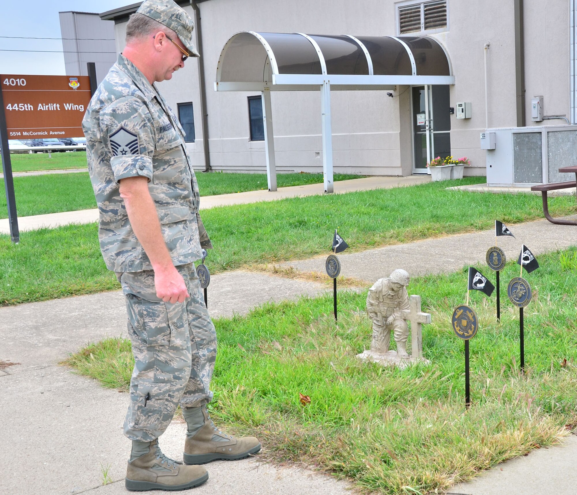 WRIGHT-PATTERSON AIR FORCE BASE, OHIO – Master Sgt. Steven Palsgrove, 445th Operations Support Squadron transportation operations specialist, visits the POW/MIA memorial set up in front of the 445th Airlift Wing Headquarters building Sept. 21. The United States’ National POW/MIA Recognition Day is observed across the nation on the third Friday of September each year. Many Americans take the time to remember those who were prisoners of war (POW) and those who are missing in action (MIA), as well as their families. (U.S. Air Force photo/Stacy Vaughn)