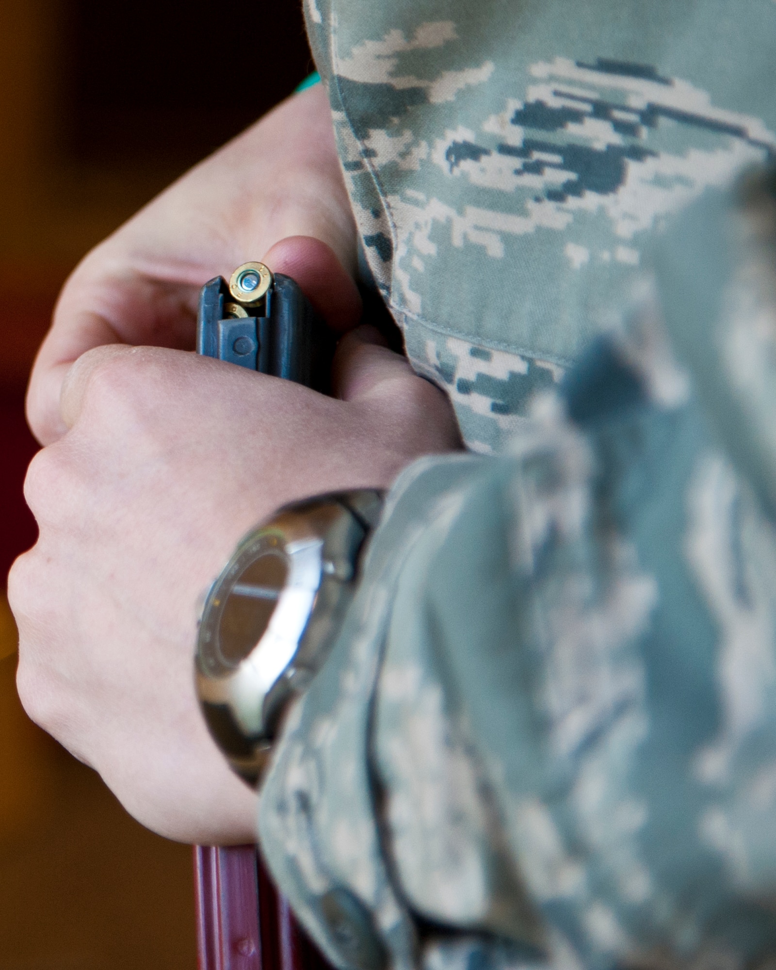 ALTUS AIR FORCE BASE, Okla. -- Maj. Rebb Jones, 97th Air Mobility Wing chief executive, loads 5.56mm frangible ball ammunition into a magazine at the Combat Arms firing range Sept. 20, 2012. Jones was a participant in the 2012 Elementary Level Excellence in Competition. Competitors shot a total of 60 rounds with the M-16A2 service rifle during the EIC. (U.S. Air Force photo by Senior Airman Kenneth W. Norman / Released)