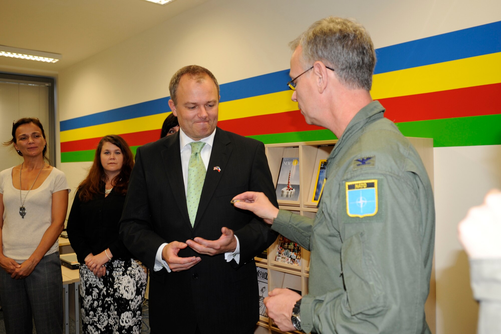 Brett Gray, executive director, 1st International School of Ostrava is presented a coin by Col. Joseph Jones, the 307th Bomb Wing vice commander, during a visit to the school by 307 BW crewmembers on Sept. 19, 2012. The aircrew visited the school and answered questions from the students relating to their military jobs. The wing is participating in the NATO Days Air Show in Ostrava, Czech Republic, where they are displaying a B-52 Stratofortress Sept. 22-23. (U.S. Air Force photo by Senior Master Sgt. Jessica Daurizio/Released)