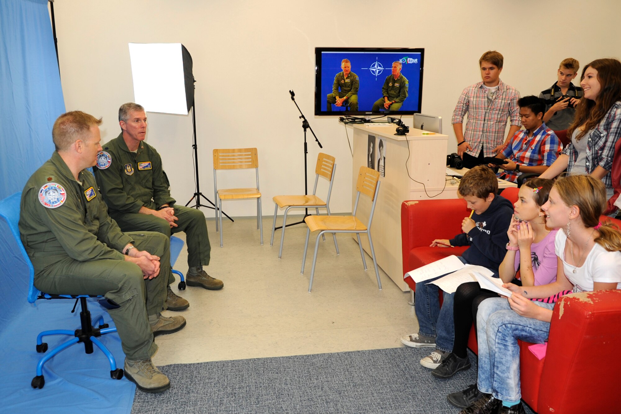 Maj. Bryan Bailey and Lt. Col. James Morriss, both from the 307th Bomb Wing are interviewed by broadcasting students from the 1st International School of Ostrava during a visit there to enlighten the students on the American military Sept. 19, 2012. The aircrew visited the school and answered questions from the students relating to their military jobs. The wing is participating in the NATO Days Air Show in Ostrava, Czech Republic, where they are displaying a B-52 Stratofortress Sept. 22-23. (U.S. Air Force photo by Senior Master Sgt. Jessica Daurizio/Released)