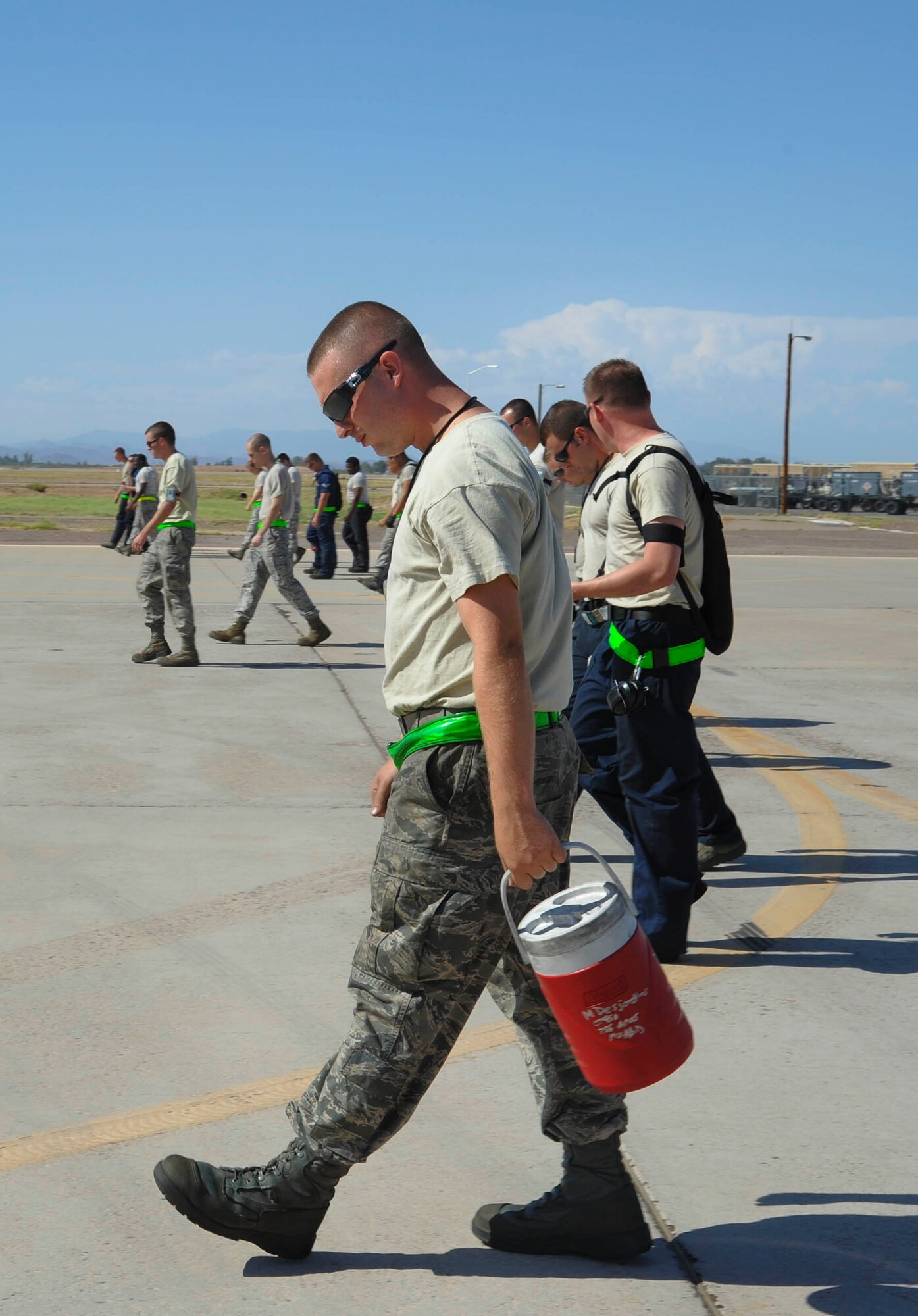Members of the 308th Aircraft Maintenance Unit perform a foreign object debris walk on the flightline at Luke Air Force Base. A wing-wide FOD walk is scheduled for 6:45 a.m. Sept. 27, 2012. (U.S. Air Force photo by Staff Sgt. Darlene Seltmann)