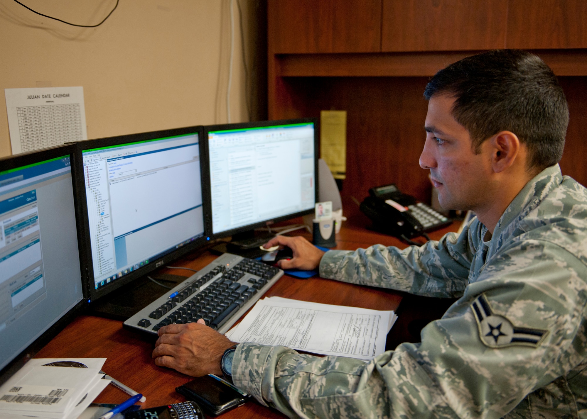 U.S. Air Force Airman 1st Class Gustavo Perez, 23d Communications Squadron, looks at work order tickets  submitted by base personnel for computer assistance Aug. 30, 2012, at Moody Air Force Base, Ga. Although a seemingly simple task, the 23d CS takes in a lot of responsibility, receiving 500 to600   tickets a week. (U.S. Air Force photo by Senior Airman Eileen Meier/Released)