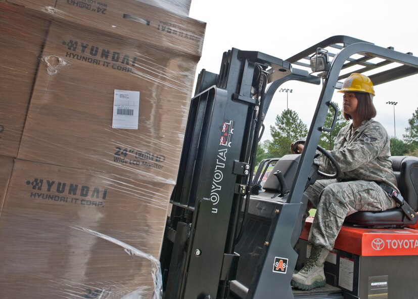 U.S. Air Force Senior Airman Cheranda Bowie, 23d Communications Squadron, operates a forklift to move new computer equipment into the 23d CS inventory garage Aug. 30, 2012, at Moody Air Force Base, Ga. Bowie takes care of incoming purchases and keeps accountability of Moody’s communication equipment. (U.S. Air Force photo by Senior Airman Eileen Meier/Released)