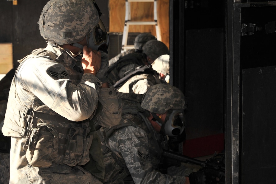 MINOT AIR FORCE BASE, N.D. -- Senior Airman Paul Olmos, member of the 91st Security Forces Group’s Global Strike Challenge team, don’s his gas mask during combat arms training and maintenance here, Sept. 18. Minot Airmen from both the 5th Bomb Wing and the 91st Missile Wing are participating in this year's Global Strike Challenge from June through November, to showcase the world's premier bomber and ICBM forces and recognize outstanding AFGSC personnel and teams. (U.S. Air Force photo/Senior Airman Brittany Y. Auld)