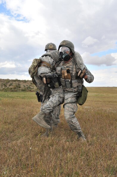 MINOT AIR FORCE BASE, N.D. – Senior Airman Isai Reyes, 91st Security Forces Group tactical response force team, fireman carries his wingman to safety during a training exercise here, Sept.6. Minot Airmen from both the 5th Bomb Wing and the 91st Missile Wing are participating in this year's Air Force Global Strike Command Global Strike Challenge during the months of June through November to showcase the world's premier bomber and ICBM forces and to recognize outstanding AFGSC personnel and teams.    (U.S. Air Force photo/Senior Airman Brittany Y. Auld)