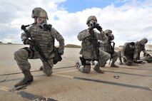 MINOT AIR FORCE BASE, N.D. -- Airmen from the 91st Security Forces Group’s Global Strike Challenge team, don their gas masks during a simulated gas attack here, Sept.6. Minot Airmen from both the 5th Bomb Wing and the 91st Missile Wing are participating in this year's Air Force Global Strike Command Global Strike Challenge during the months of June through November to showcase the world's premier bomber and ICBM forces and to recognize outstanding AFGSC personnel and teams. (U.S. Air Force photo/Senior Airman Brittany Y. Auld)