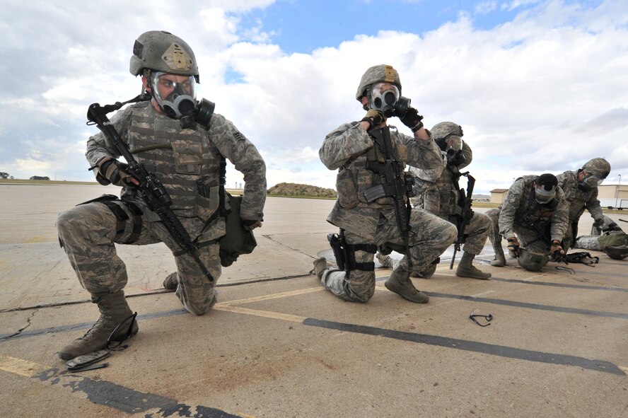 MINOT AIR FORCE BASE, N.D. -- Airmen from the 91st Security Forces Group’s Global Strike Challenge team, don their gas masks during a simulated gas attack here, Sept.6. Minot Airmen from both the 5th Bomb Wing and the 91st Missile Wing are participating in this year's Air Force Global Strike Command Global Strike Challenge during the months of June through November to showcase the world's premier bomber and ICBM forces and to recognize outstanding AFGSC personnel and teams. (U.S. Air Force photo/Senior Airman Brittany Y. Auld)