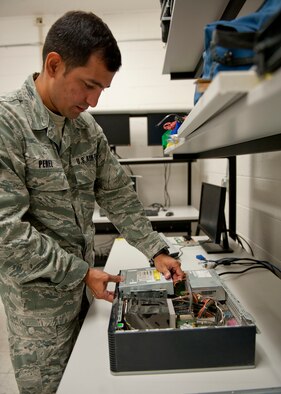 U.S. Air Force Airman 1st Class Gustavo Perez, 23d Communications Squadron, disassembles a computer at a workbench Aug. 30, 2012, at Moody Air Force Base, Ga. There are many different squadrons that support the Air Force’s communication mission, such as asset management, vulnerability reduction, troubleshooting everyday computer problems and providing base personnel communication through Land Mobile Radios. (U.S. Air Force photo by Senior Airman Eileen Meier/Released)